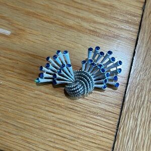 Vintage 1955-1969 silver toned broach with blue stones